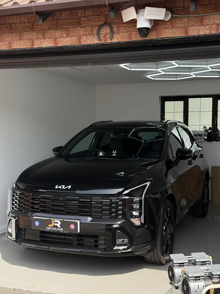 Black Kia SUV in the J.R Detailing unit